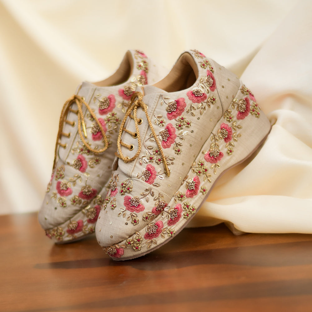 Ethnic inspired sneakers with blush pink motifs on neutral fabric base and cushioned insole