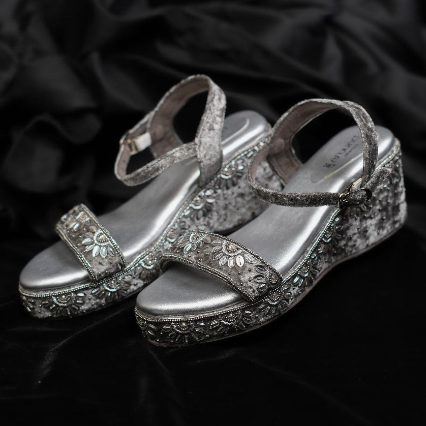 Metallic silver floral embroidered sandals with ankle straps
