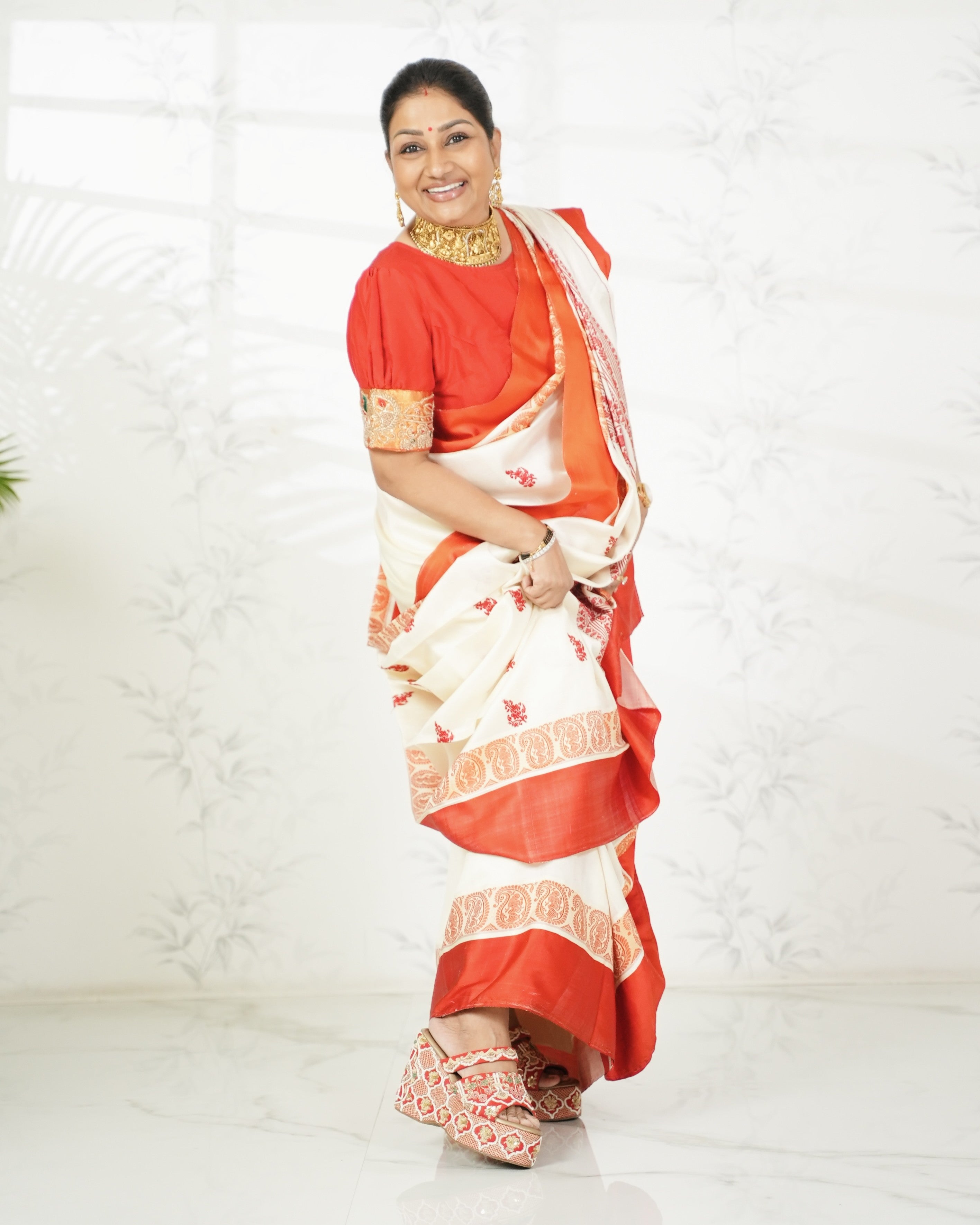 Dolly Jain wearing comfortable red zardozi heels from Around Always under an Indian Saree