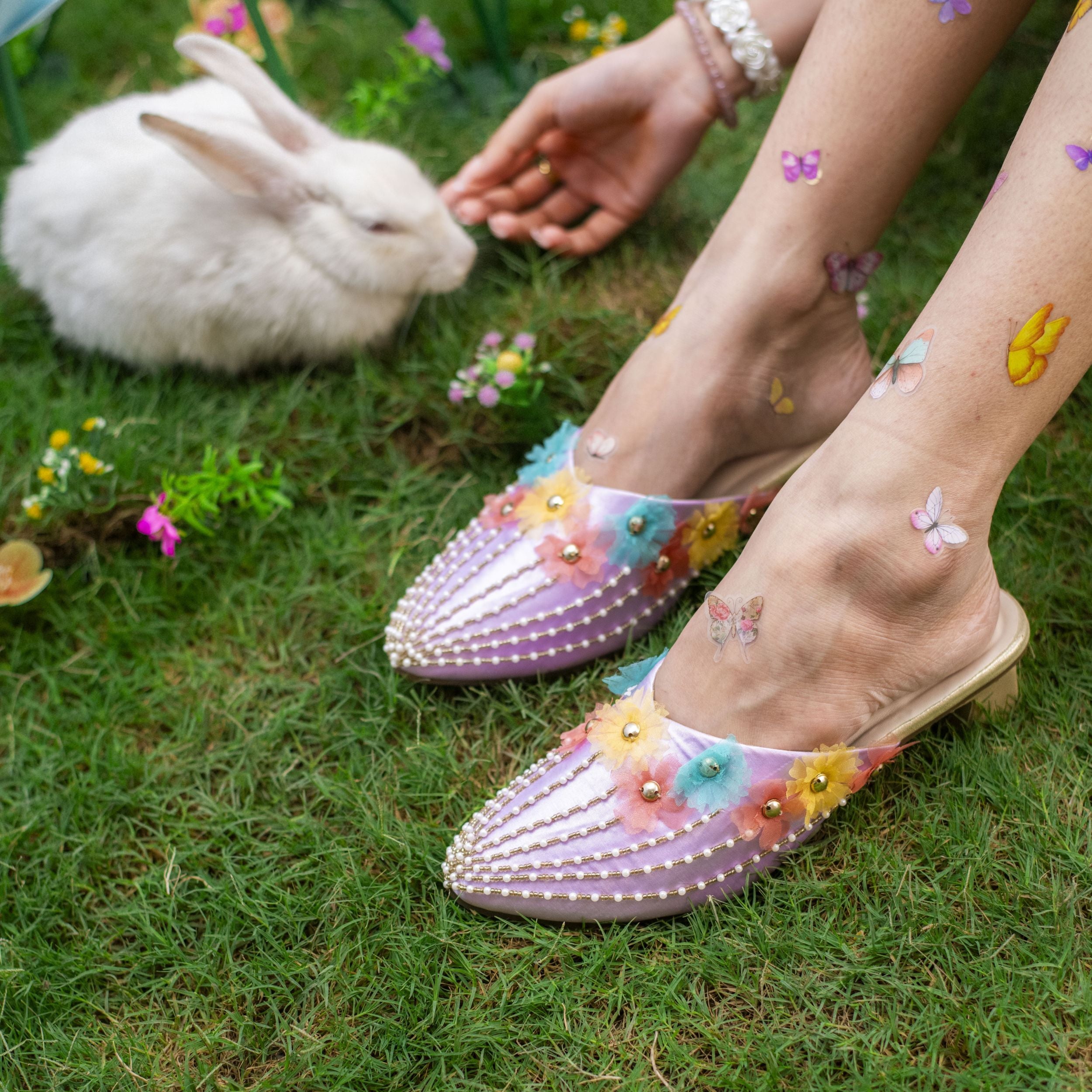 Lavender pointed heels with floral appliqué and pearl detailings
