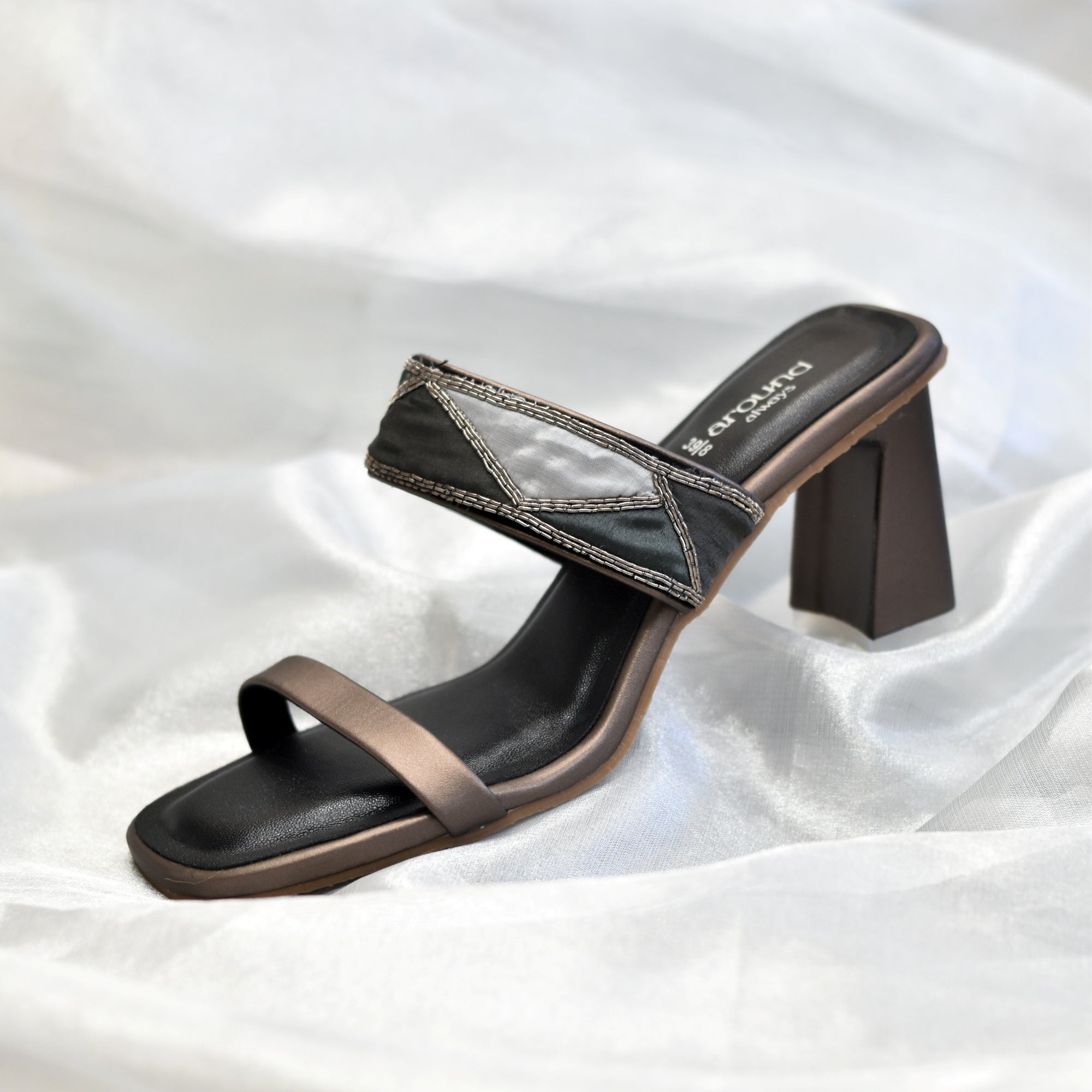Black sandal with a flared block heel with designer straps and slip-on pattern 