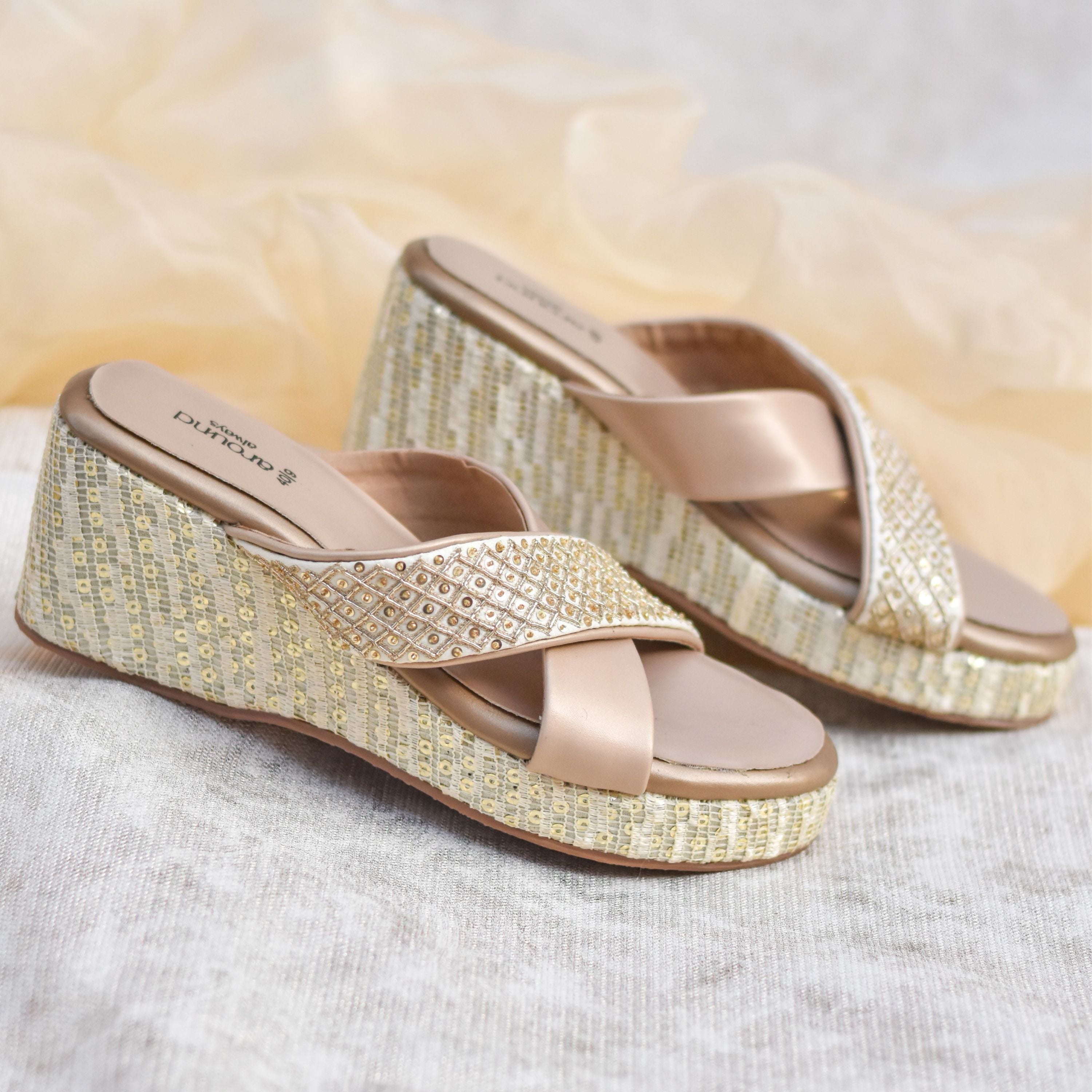 Comfortable party wedges for women with shimmer straps and cushioned sole.