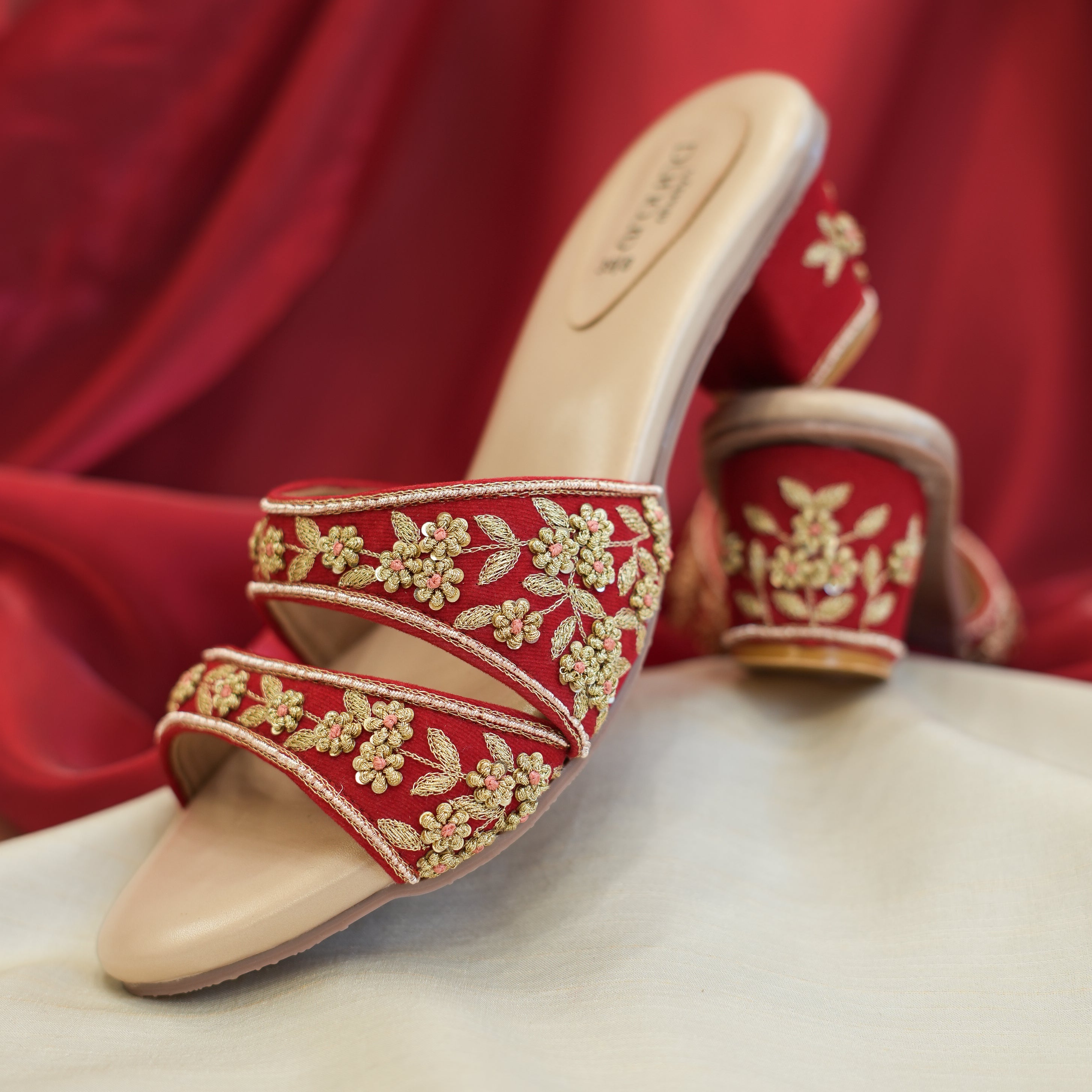 Festive red block heel sandals with embellished straps
