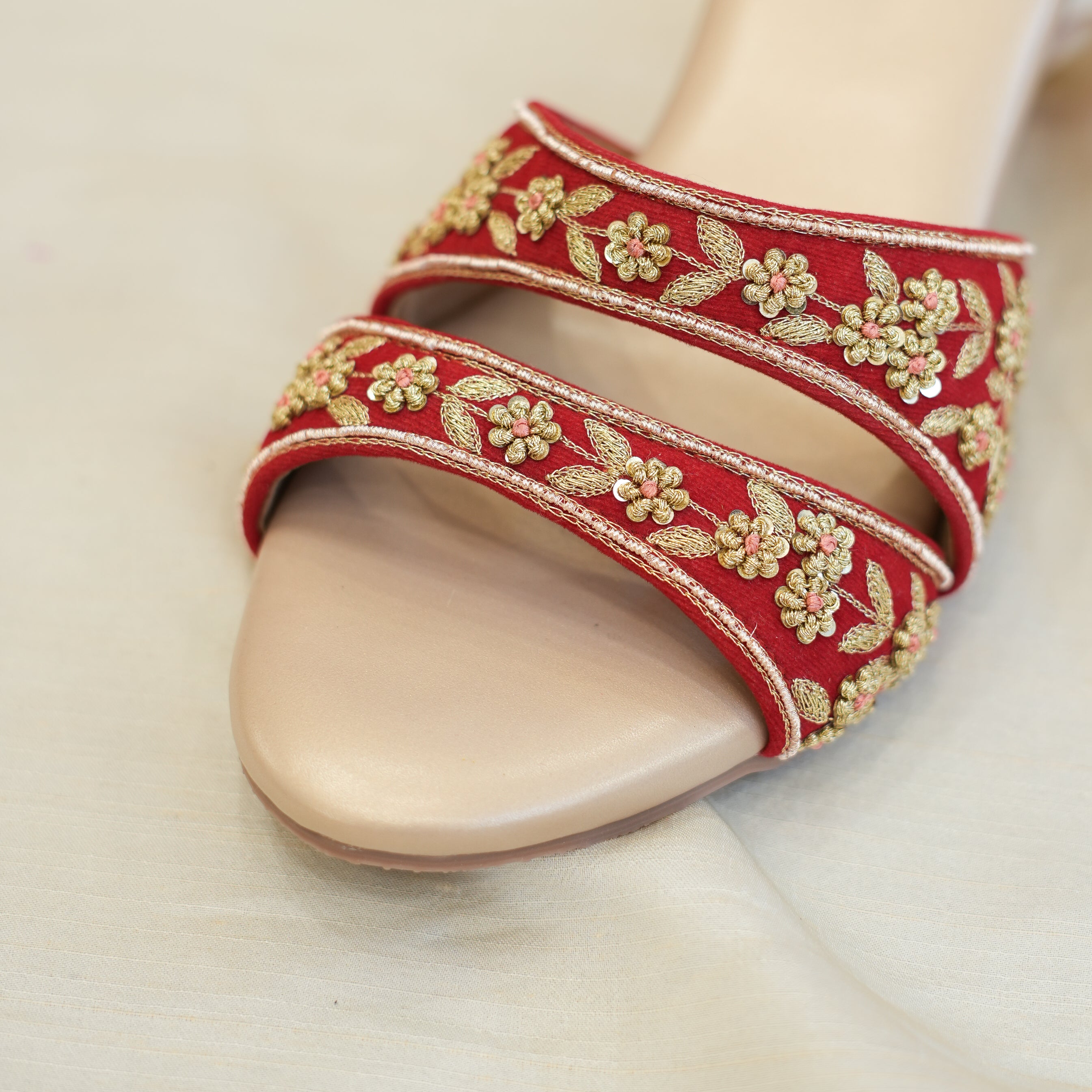 Red and gold embroidered sandals for festive occasions
