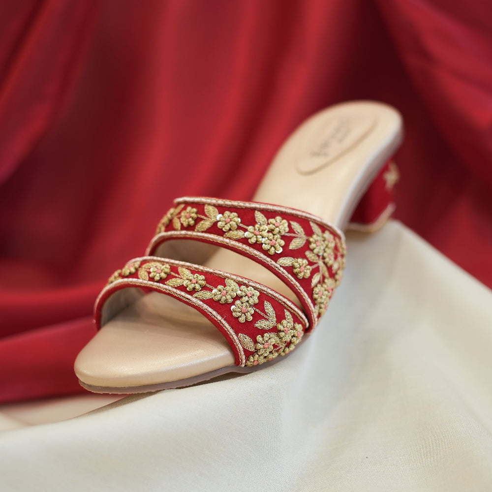 Red block heel sandals with intricate gold floral embroidery
