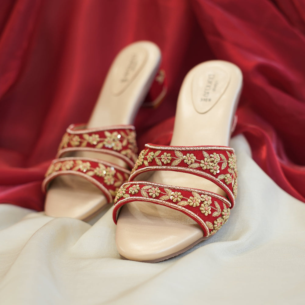 Red embroidered sandals with gold floral detailing

