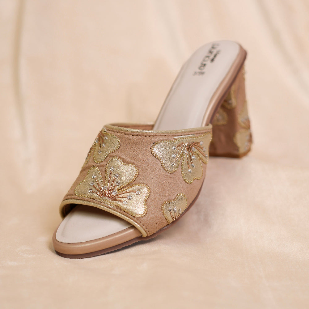 Beige single-strap sandals with golden floral embellishment
