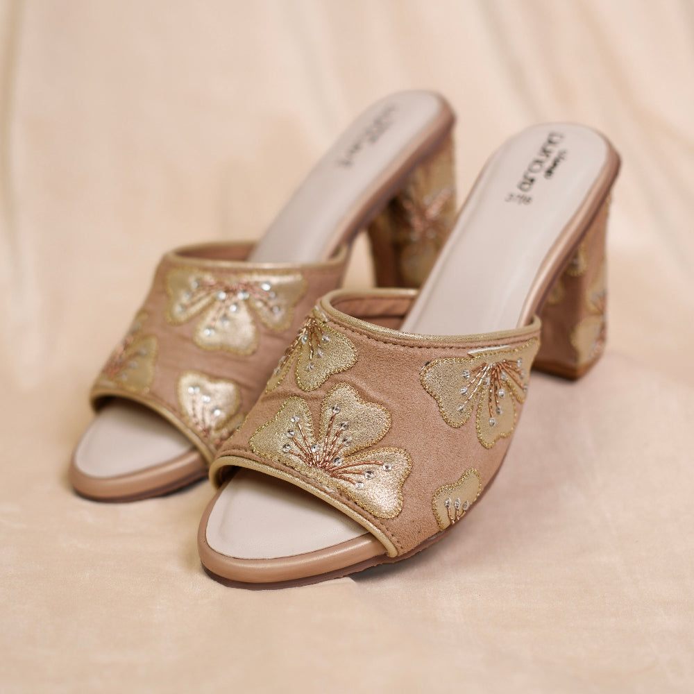 Blush beige peep-toe block heel sandals with floral detailing

