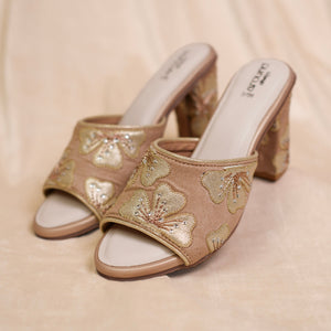 Blush beige peep-toe block heel sandals with floral detailing
