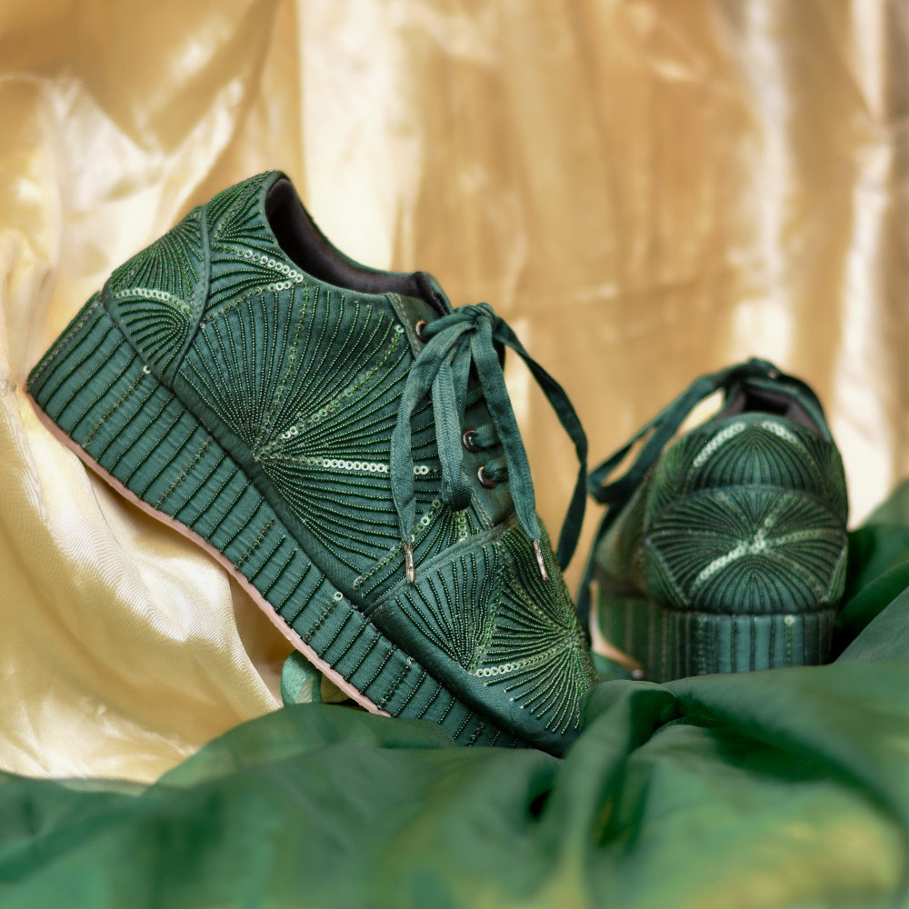 Green occasion sneakers featuring detailed geometric embroidery

