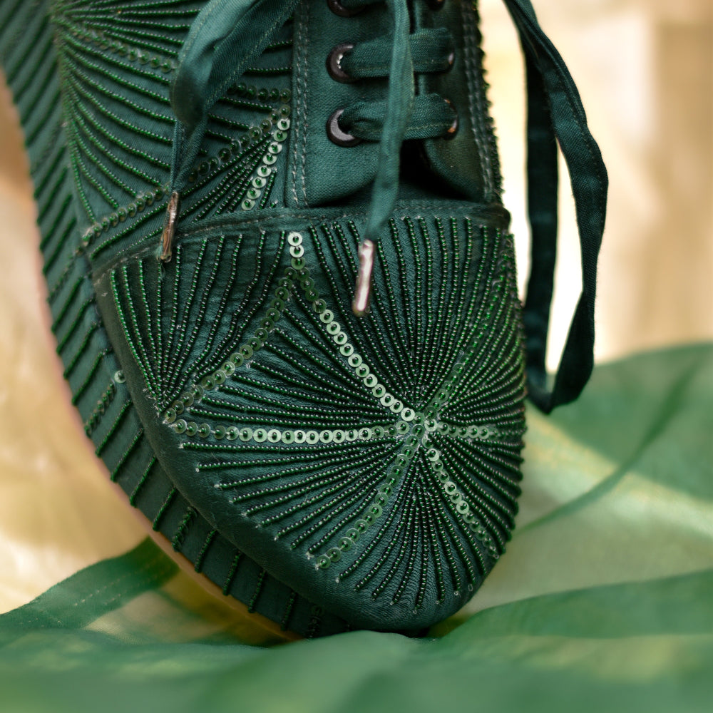 Dark green statement sneakers with detailed embroidered upper

