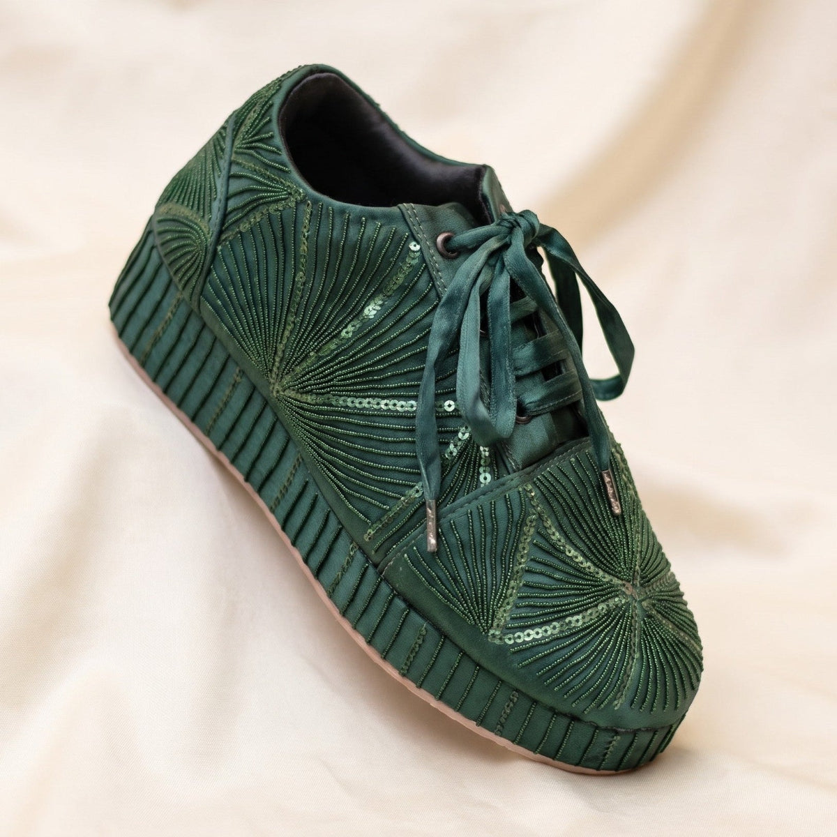 Designer cocktail shoes in emerald green with sequins and beads detailing on heels also