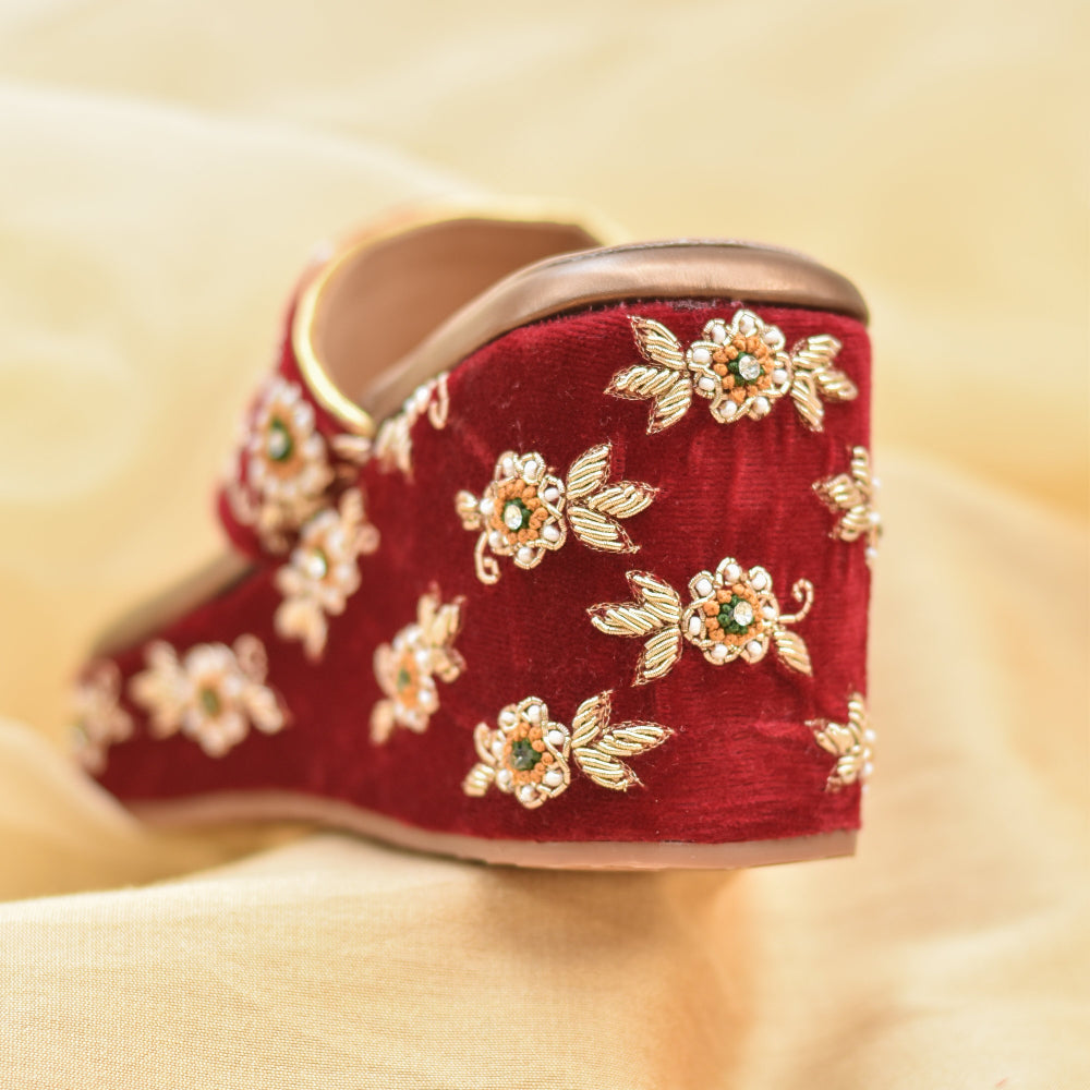 Bridal red Kolhapuri wedge with floral motifs and toe grip.