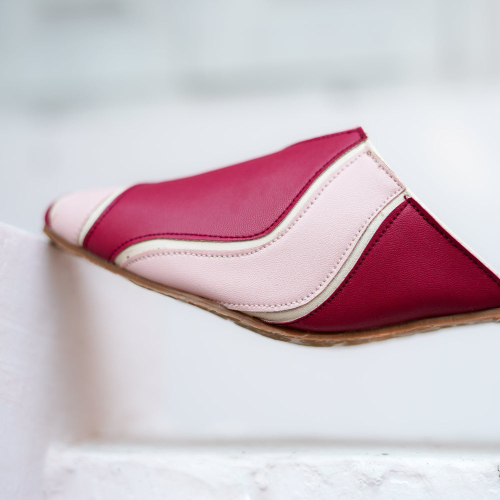 Flat mule in deep berry and soft pink tones with modern panel design

