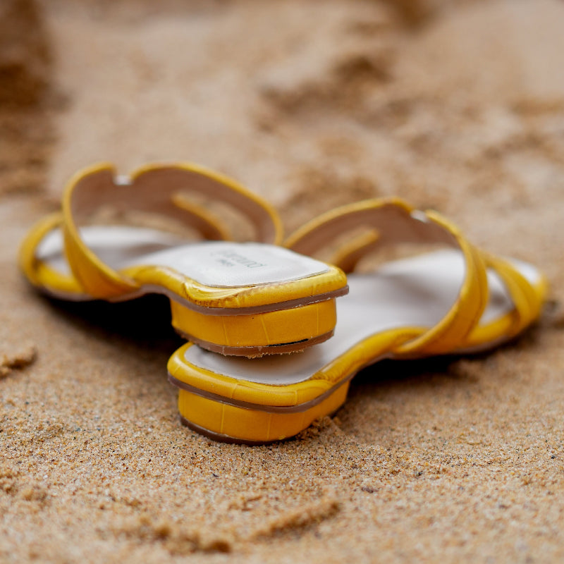 Textured yellow slider with woven-style strap detail and cushioned footbed