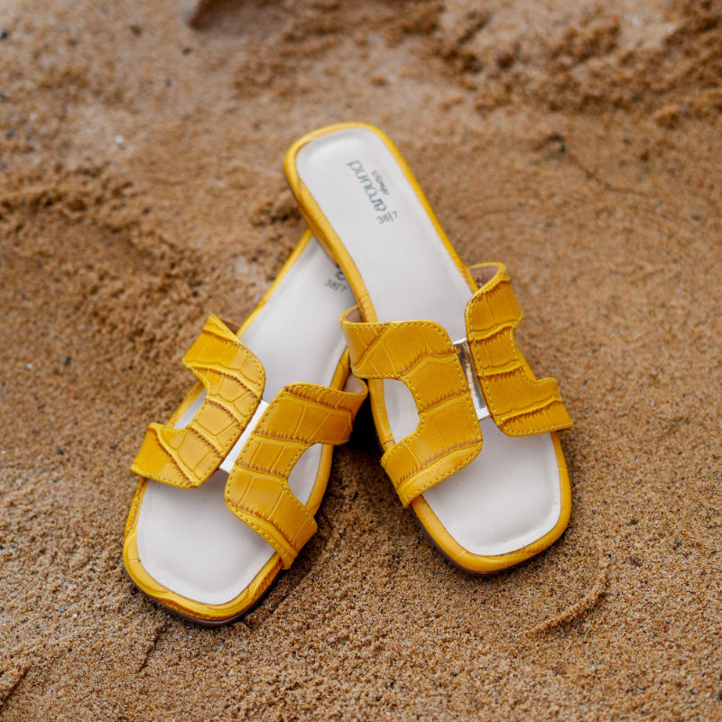 Bright yellow casual sandal with embossed pattern and open-toe construction