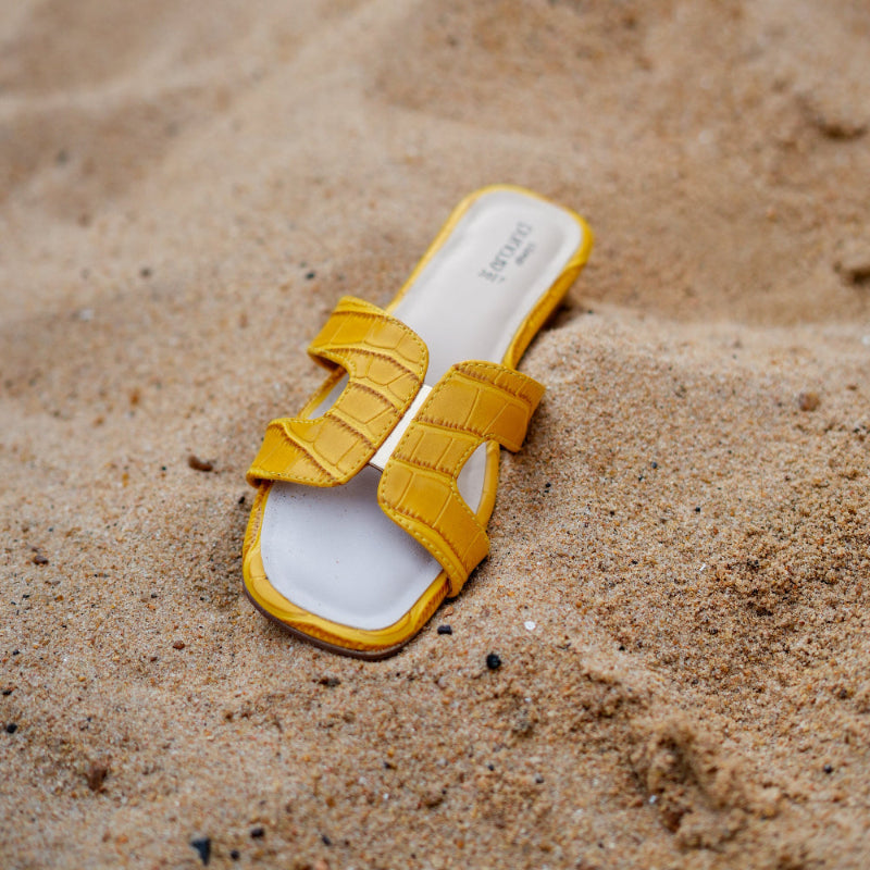 Casual yellow footwear with statement strap design and comfortable everyday fit