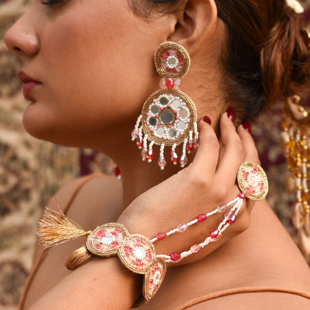 Indian bride wearing intricate gold and pastel handmade jewelry for her premium haldi look 