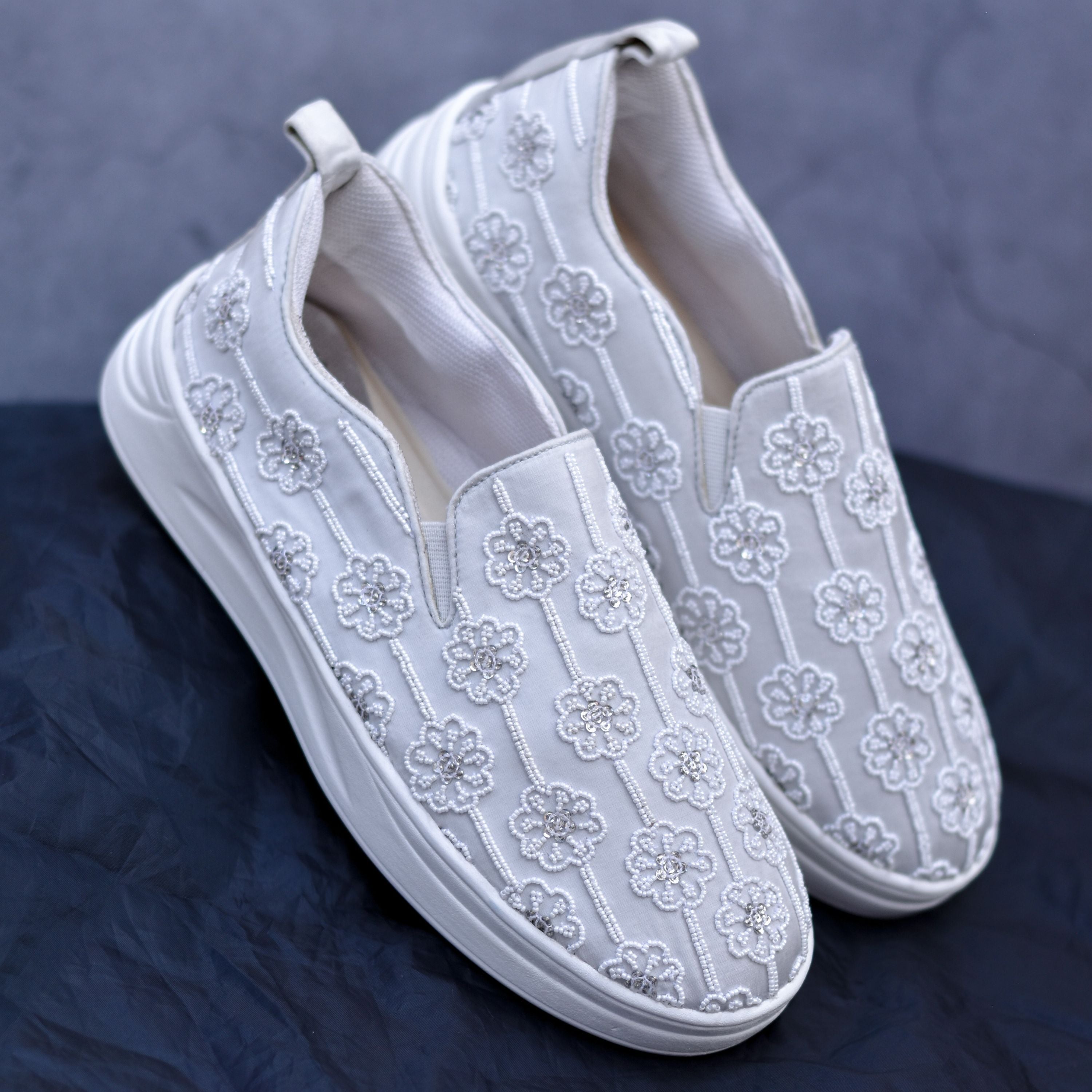 Festive slip-ons featuring floral motifs with bead detailing.