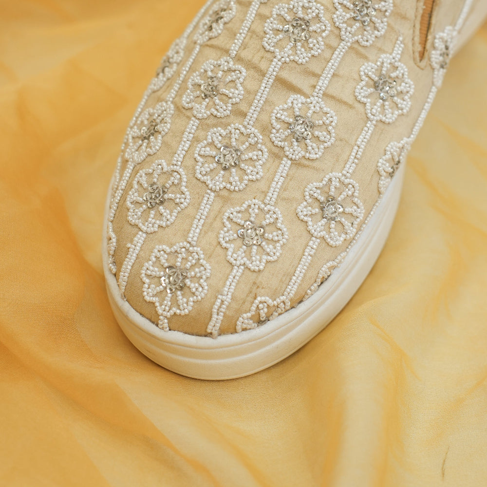 Beige occasion sneakers with garden-inspired floral pattern and raised sole
