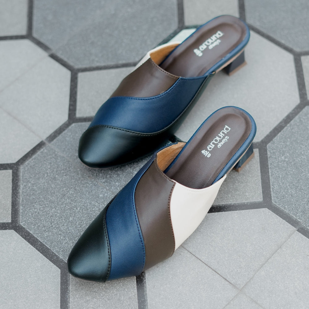 Pointed toe heeled mule in navy, charcoal, and ivory with curved panel design