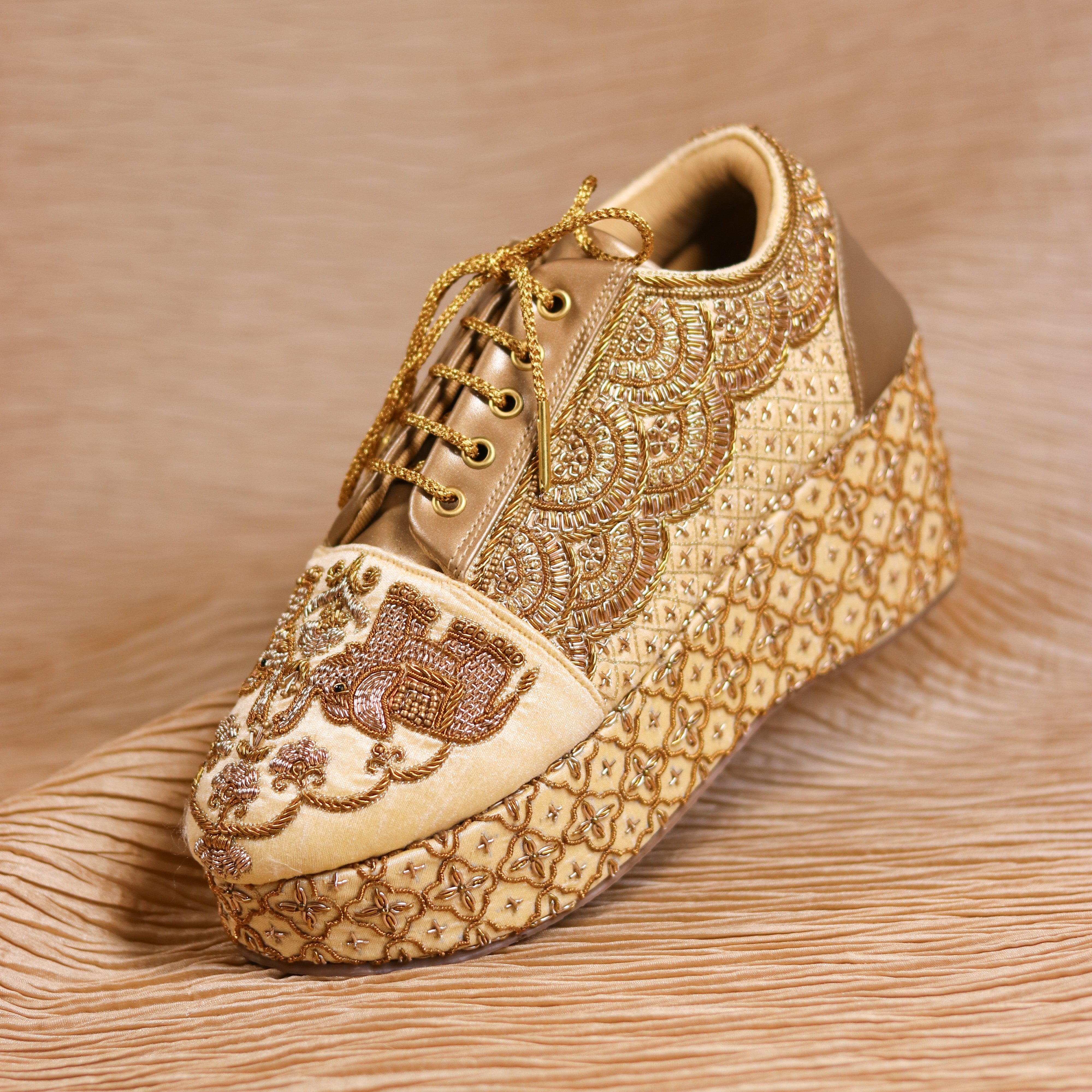 Bridal sneaker wedge in golden with scalloped panels and elephant detailing