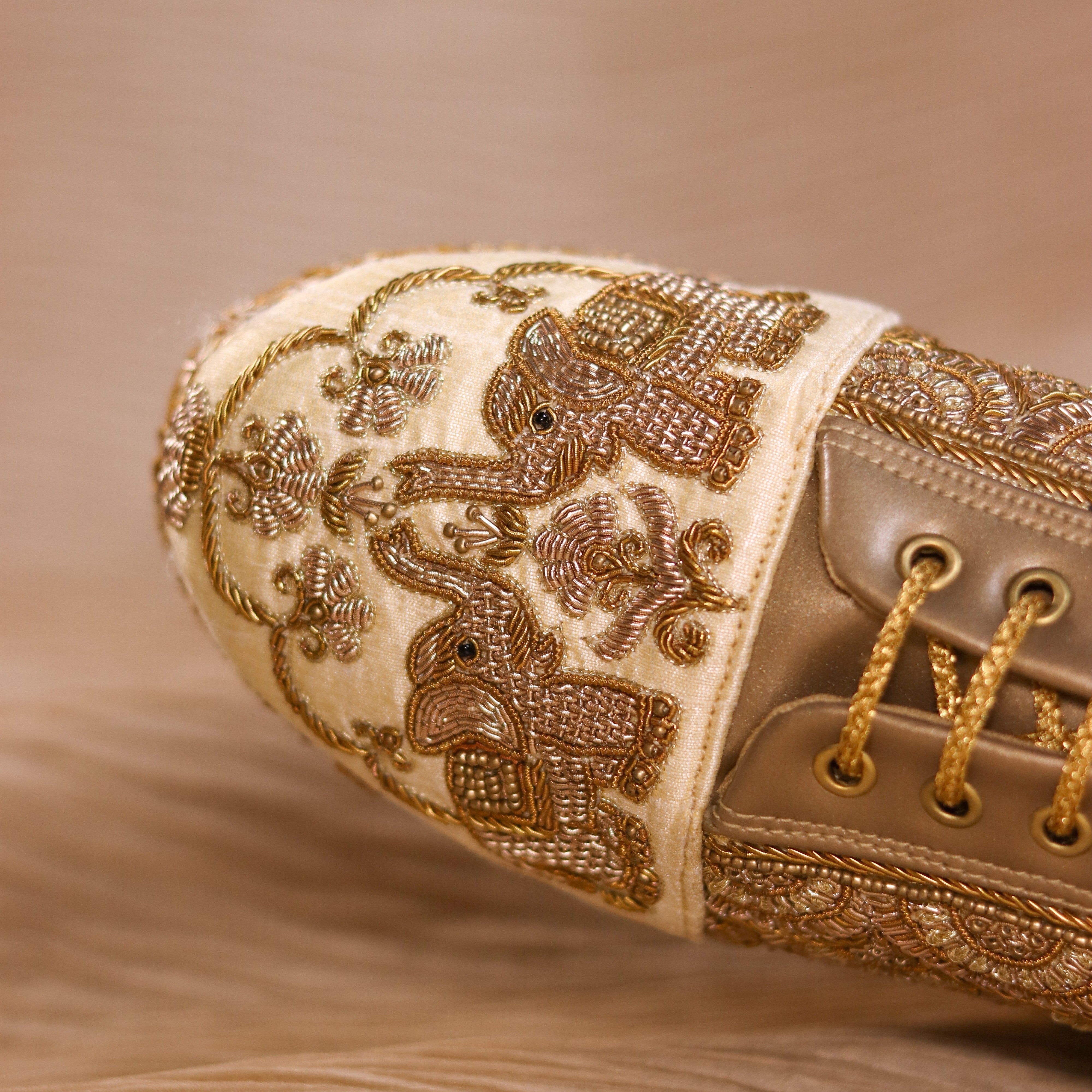 Festive wedge sneakers in golden featuring gold elephant motifs and comfortable footbed 