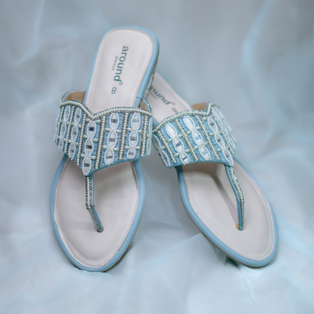 Light blue festive flats with geometric handwork and decorative flats
