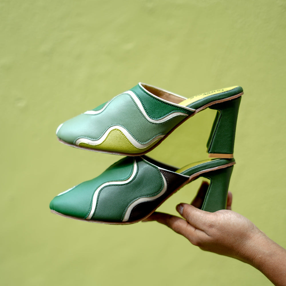 Closed-toe green mules in forest and lime tones with modern panelled design
