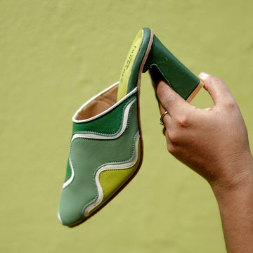 Colour-block mule heels featuring curved wave patterns and sturdy block heel
