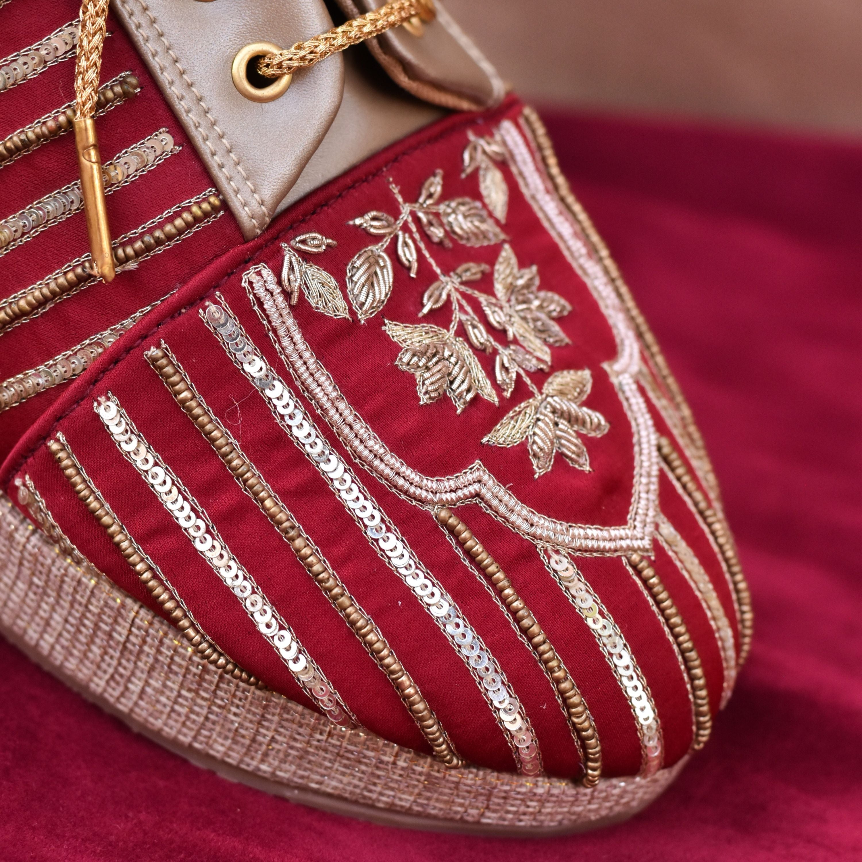 Red bridal sneakers with gold detailing and embroidered flowers.