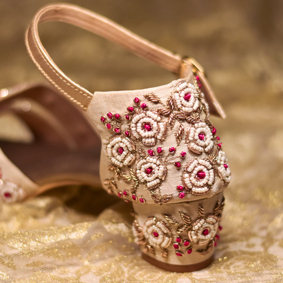 Indian wedding sandals with embroidered block heels in golden and pink tones