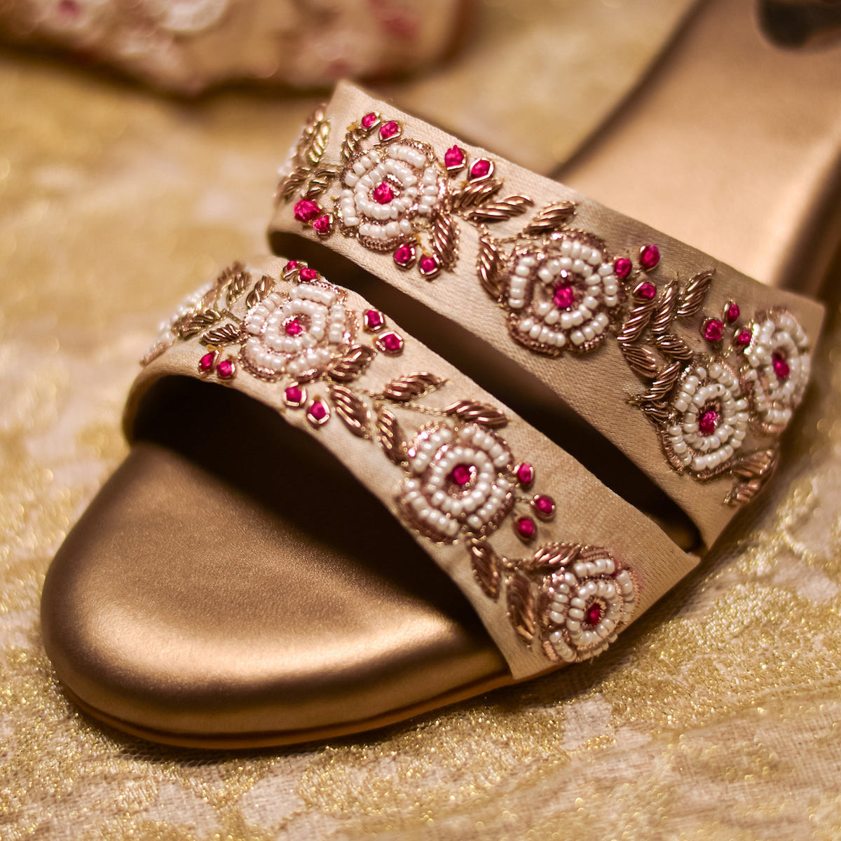 Embroidered golden sandals with floral zardozi detailing and ankle straps and cushioned soles for comfort 