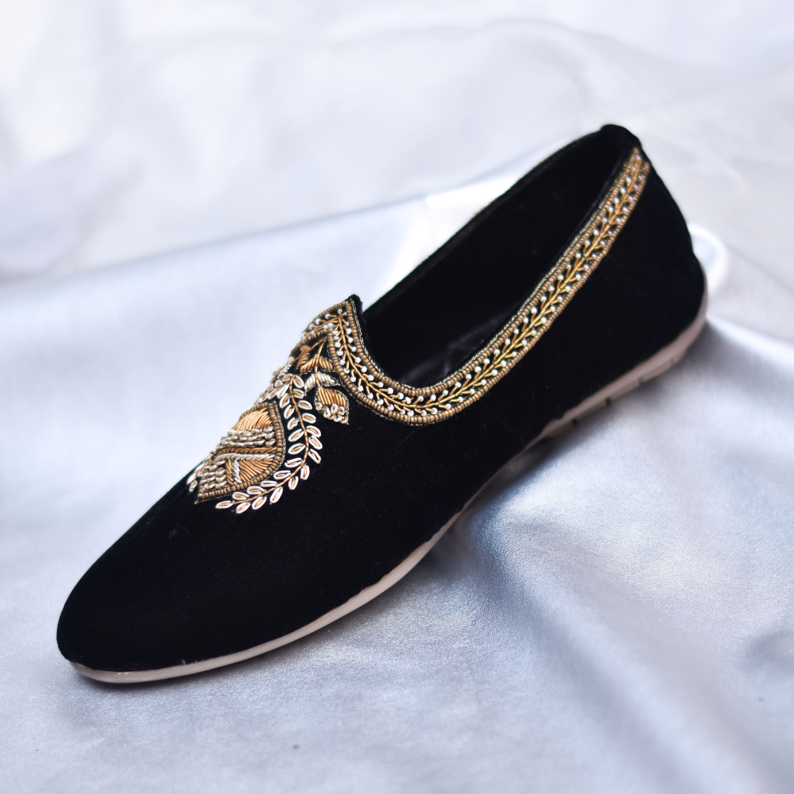 Luxury embroidered velvet shoes with detailed neckline patterns for formal occasions.