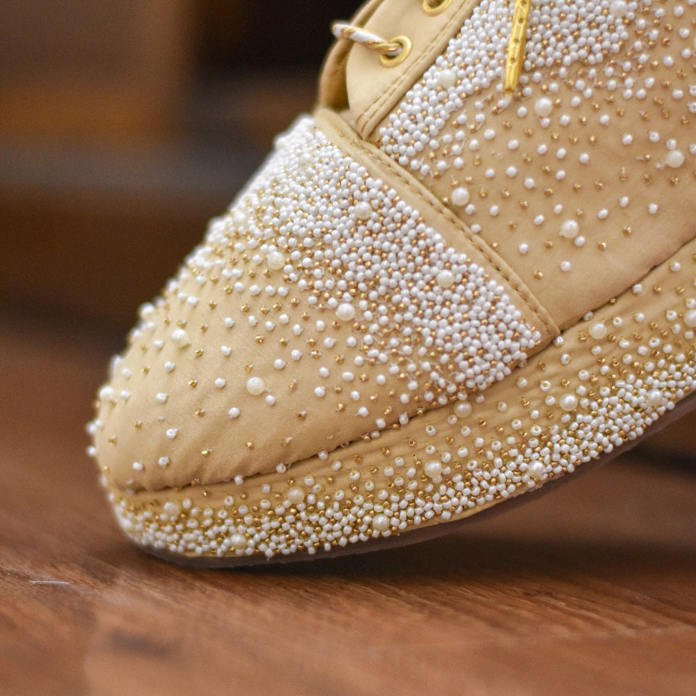 Beige Indian wedding shoes with pearl embellishments for a classic tone on tone outfit