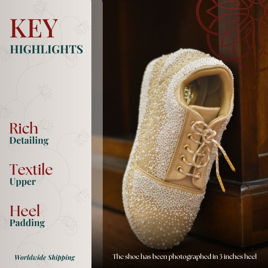 Ivory pearl embellished sneaker with lace up design and textured upper