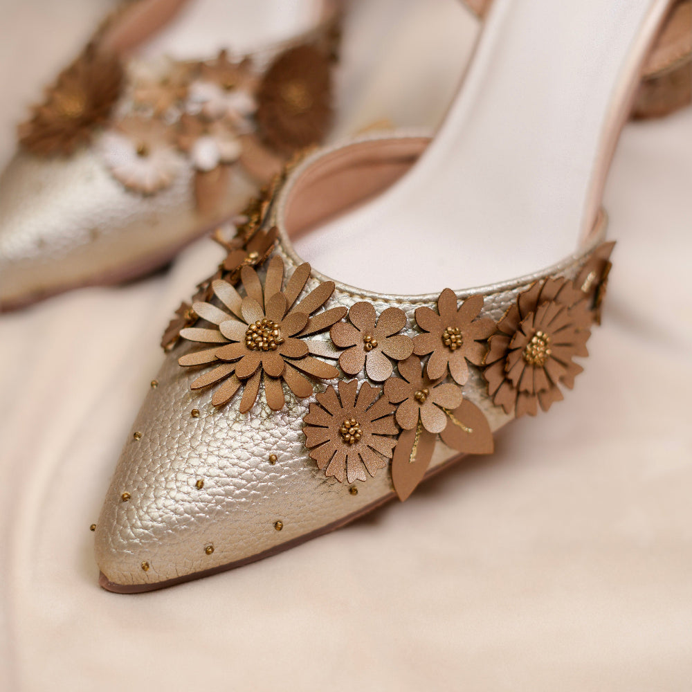 Metallic mules featuring intricate floral appliqué and beadwork
