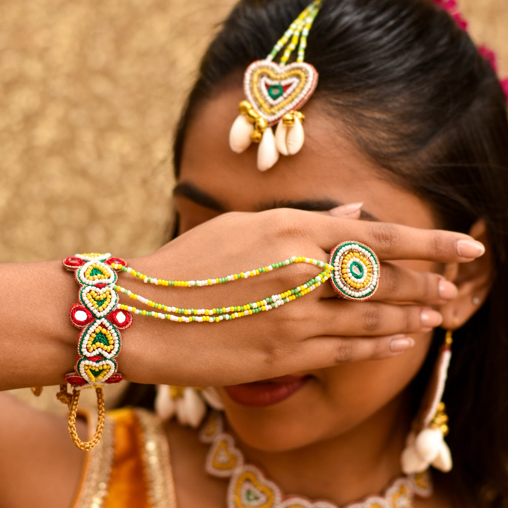 Hand accessory bracelet and ring in combination with heart and cirle shape with colourful beadwork mangtika