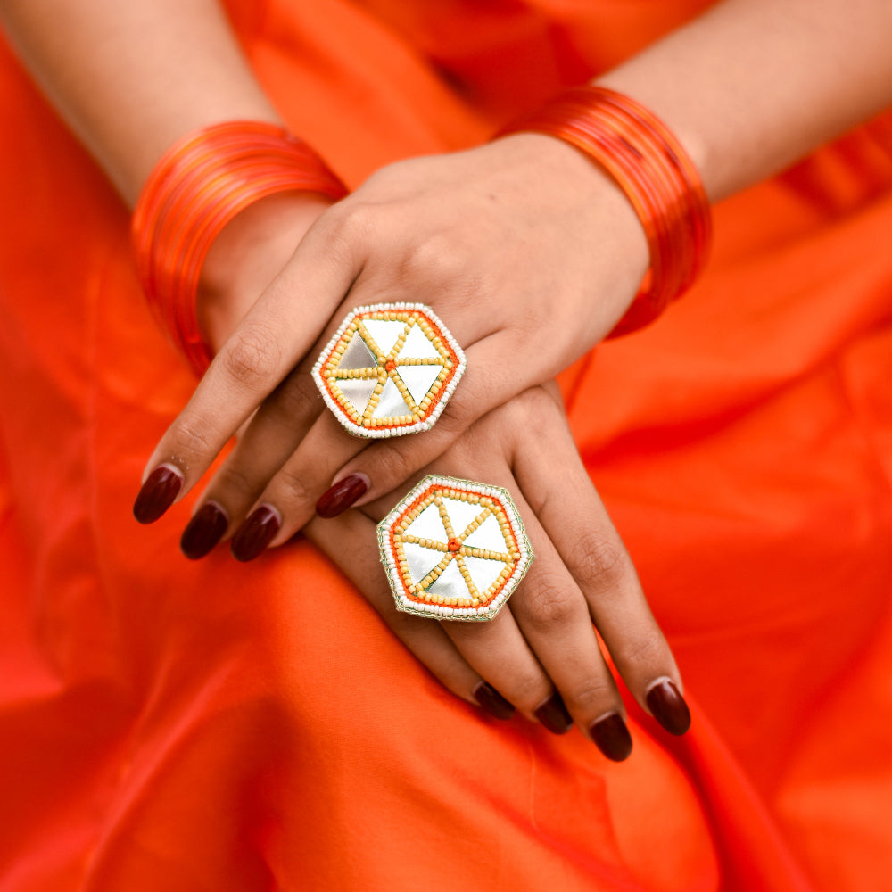 Yelloe and orange embroidered rings with mirrors for a bright holud look during weddings
