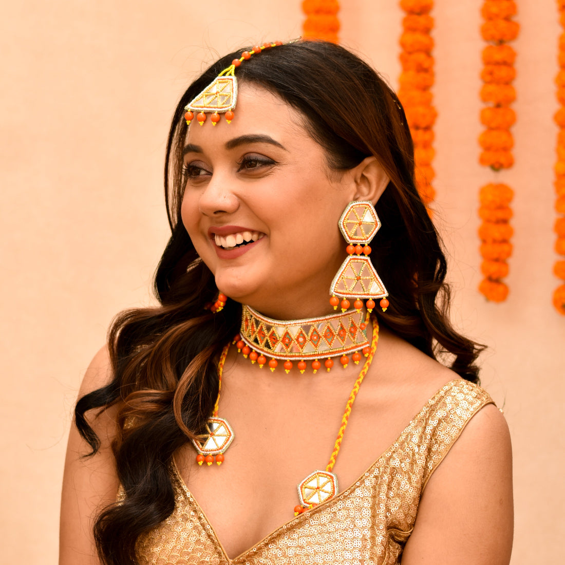 A bride wearing handmade imitation jewellery on a yellow orange beaded theme