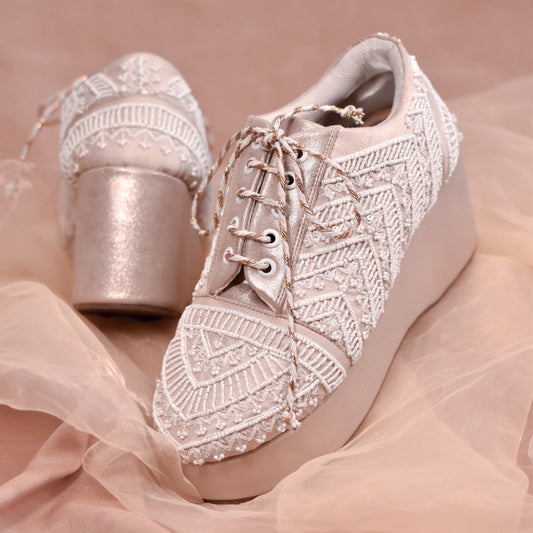 White wedding shoes with ornate handwork