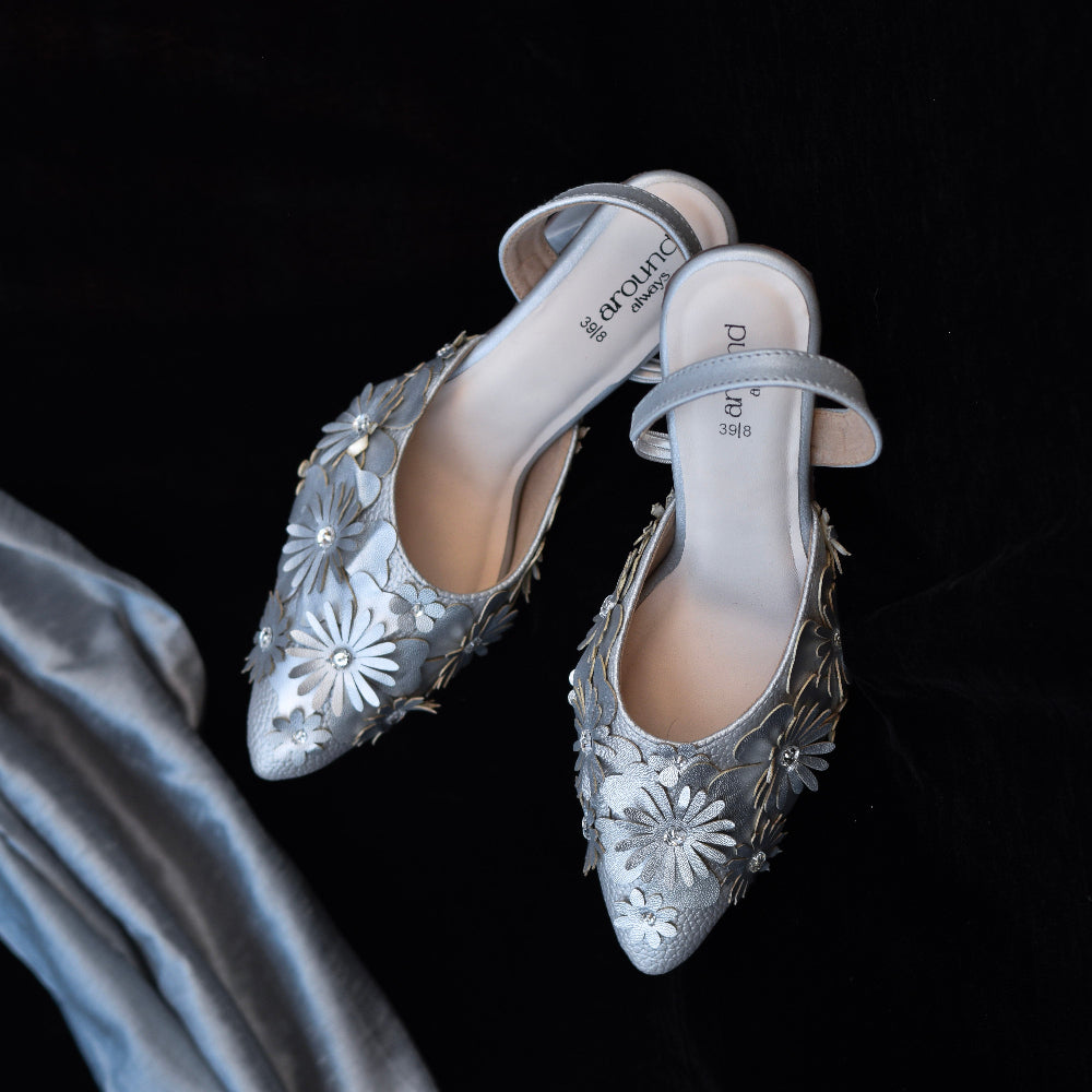 Silver pointed-toe slingback heels with layered flower detailing

