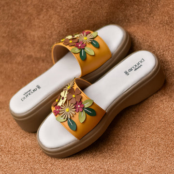 Women's yellow comfort slides with dimensional flower appliqués and cushioned sole