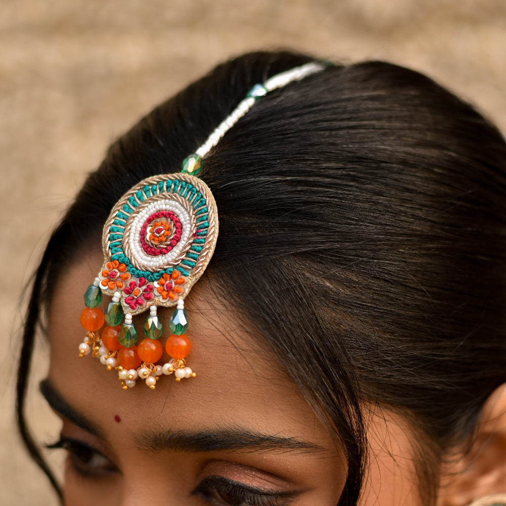 Traditional maangtika from a hadli set in festive colours