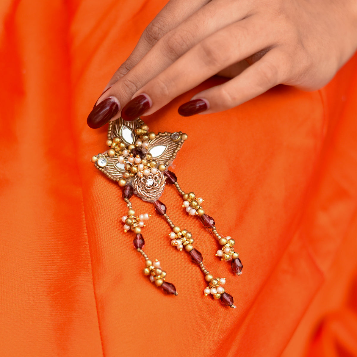 Statement earrings with floral detailing designed for festive and evening looks.