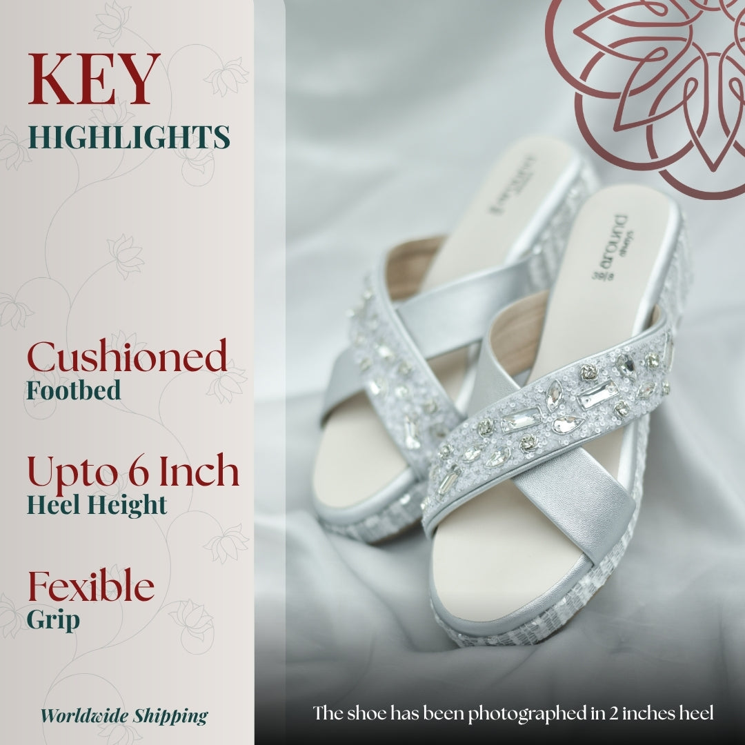 Elegant silver toned wedges featuring ornate stones and cushioned raised platform
