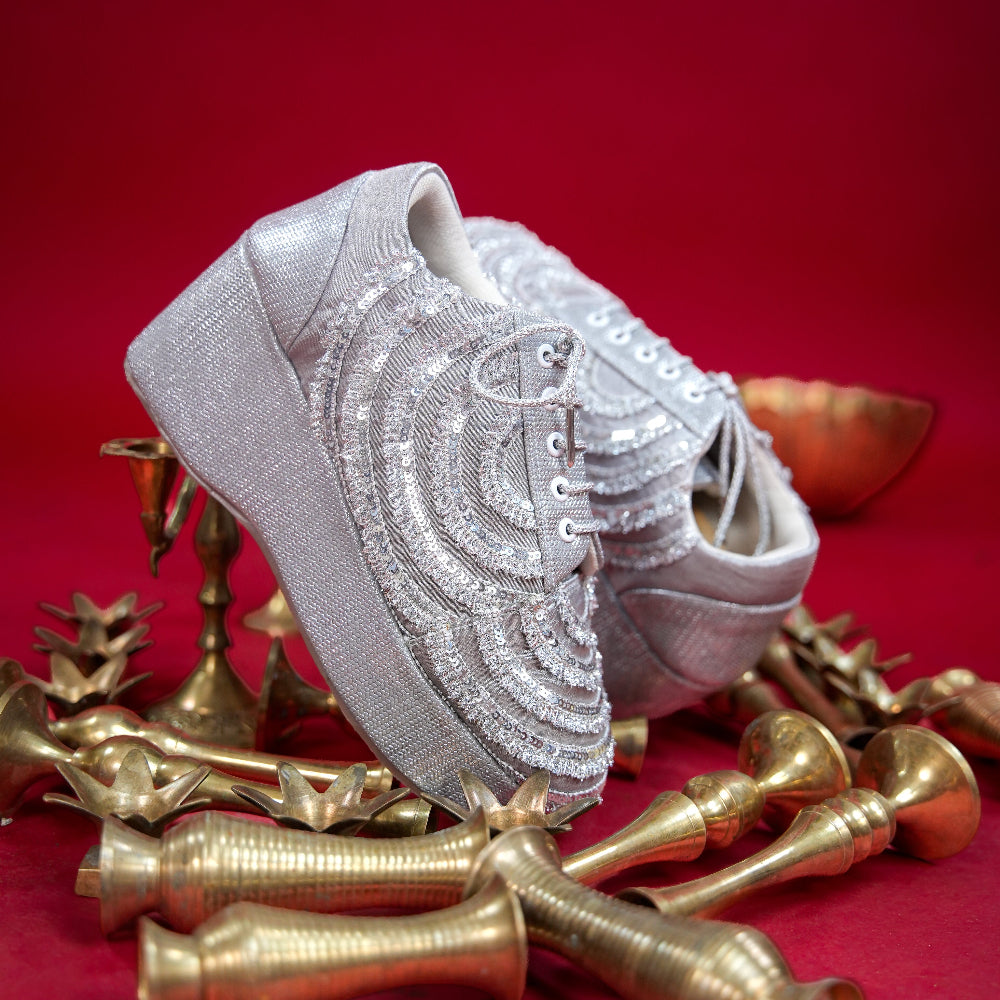Silver sneaker wedge with layered sequin detailing across the upper
