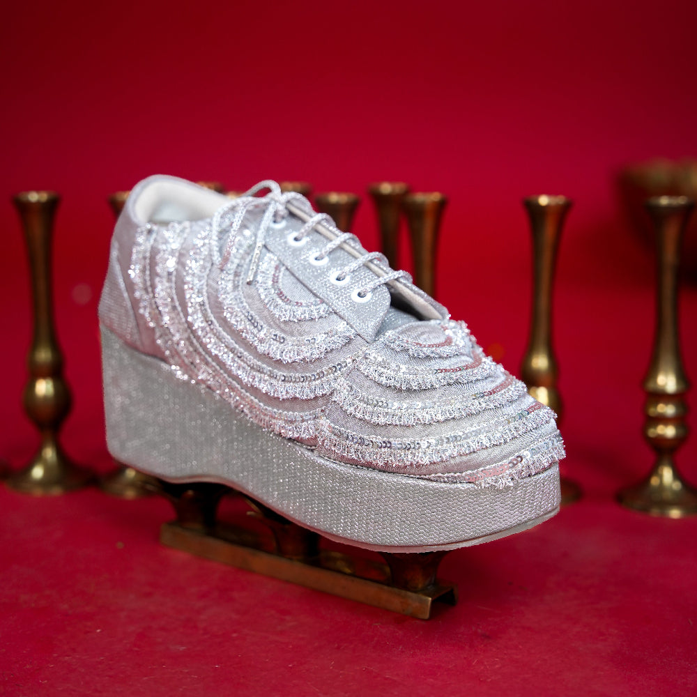 Silver wedding sneaker with elevated wedge and lace-up front
