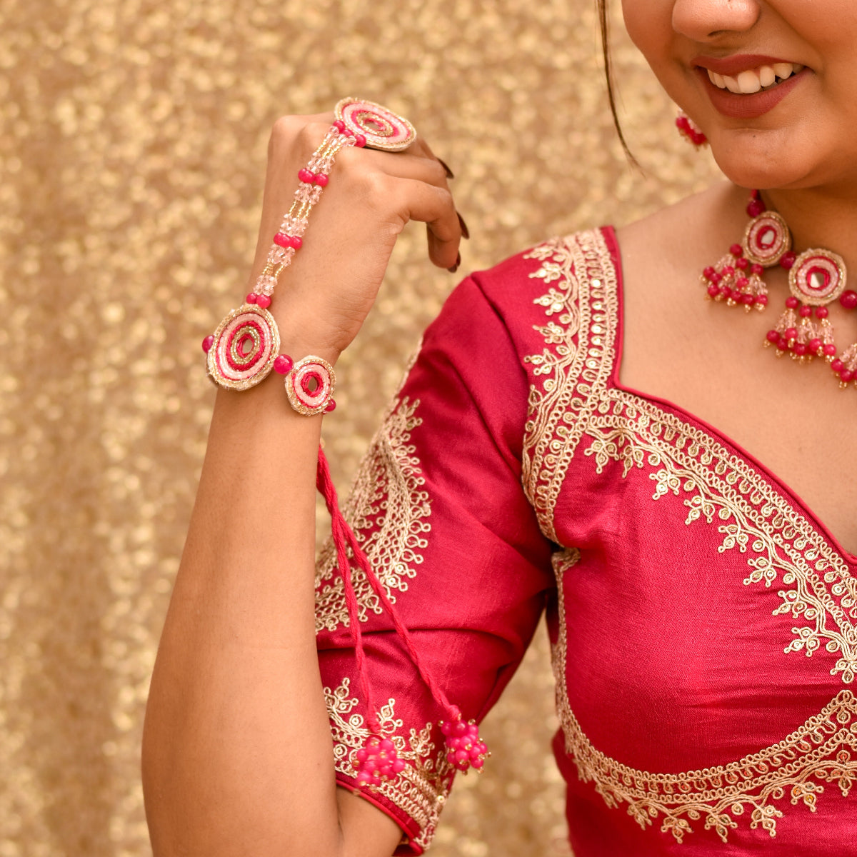Indian bride showing off her trendy beaded hathphool with long hangings