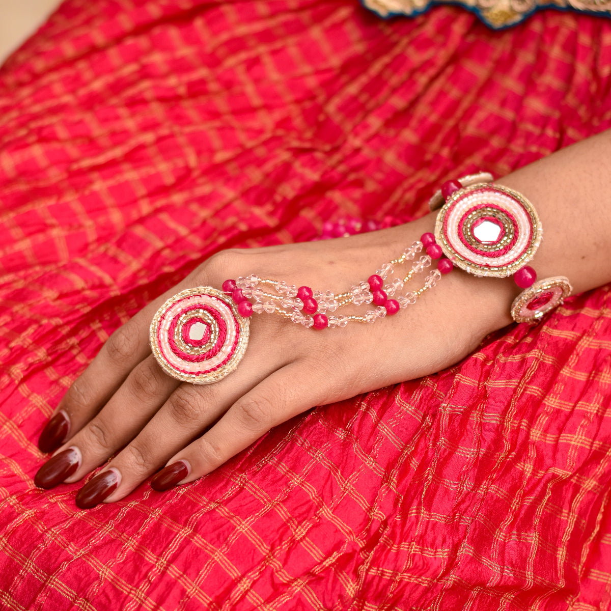 An Indian bride wearing a hand accessory called hathphool made of beads
